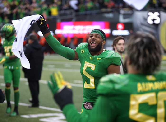 Oregon EDGE Kayvon Thibodeaux celebrates on the sideline